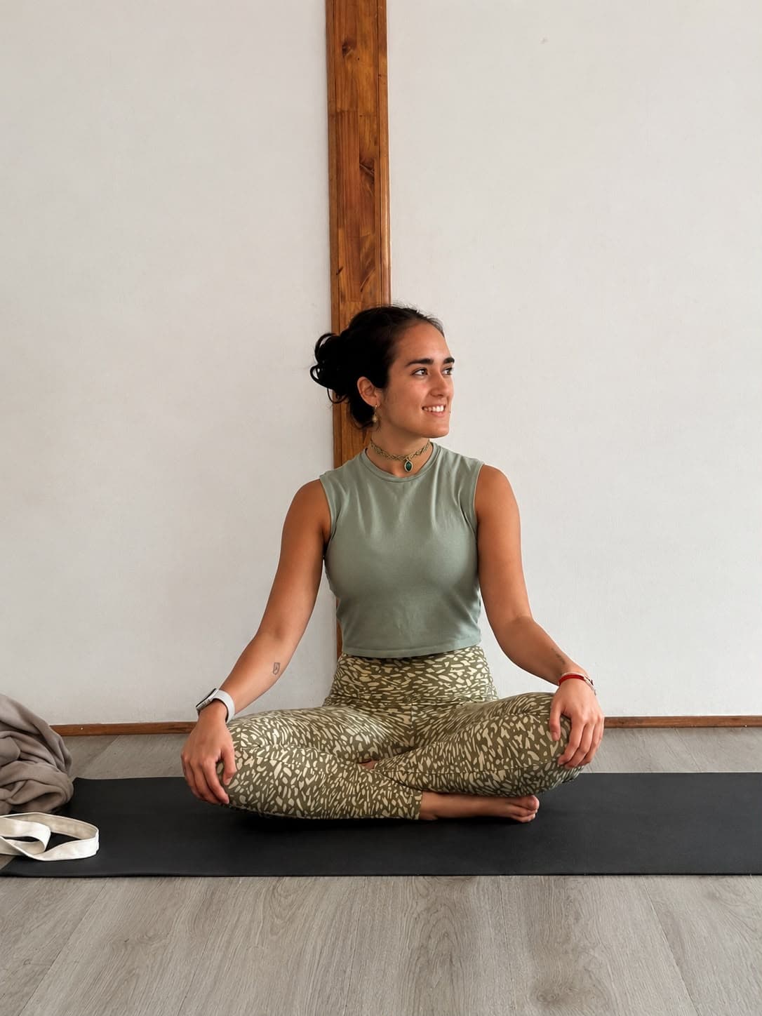 Ignacia sonriendo, sentada en el mat antes de empezar la clase